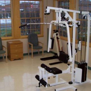 A multi-purpose exercise machine in a gym setting.