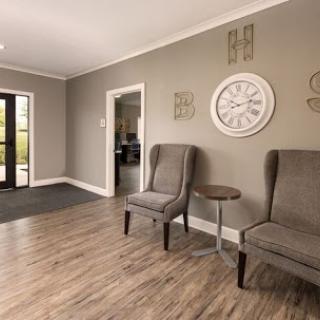A modern waiting area featuring stylish chairs and decorative wall elements.