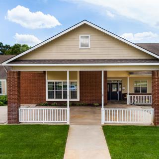A suburban house with a brick exterior and a welcoming front porch.