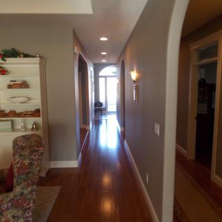 A well-lit hallway with hardwood flooring and elegant interior design features.