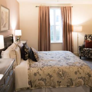 A cozy bedroom with warm lighting and floral bedding.