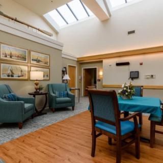 A cozy lounge area with comfortable seating and natural lighting from a skylight.