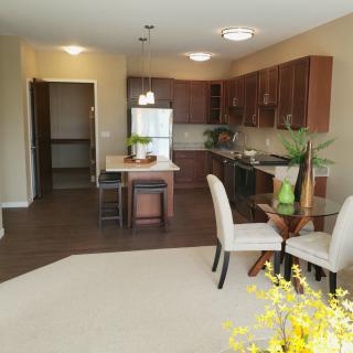 A modern open-concept kitchen and dining area with sleek furniture.