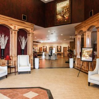 A spacious hotel lobby with elegant furniture and warm decor.