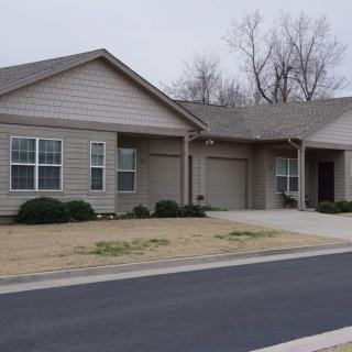 A suburban residential house with a driveway and garage.