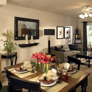 A modern living and dining area featuring stylish furniture and elegant table settings.