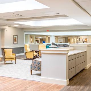 A modern and spacious lobby area with comfortable seating and a reception desk.