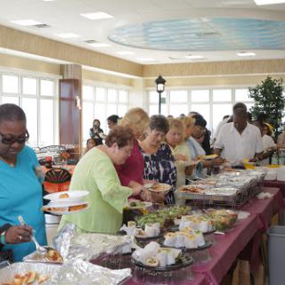Guests enjoying a diverse buffet at a lively gathering.