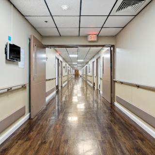 A view down a spacious, well-lit hospital hallway.