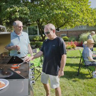 Friends enjoying a summer BBQ in the backyard.