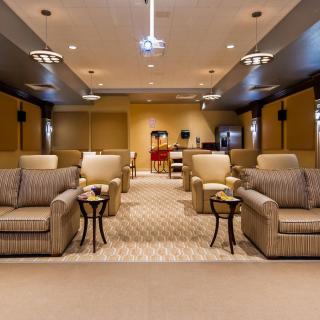 A luxurious home theater room with plush seating and modern decor.