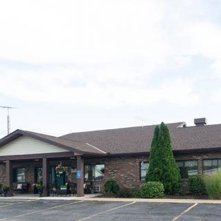 A small restaurant with a brick exterior and an adjacent parking lot.