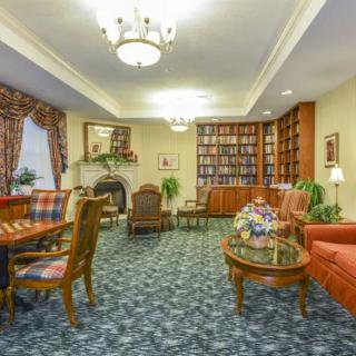A cozy library room with comfortable seating and elegant decor.