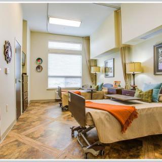 A well-decorated bedroom with two beds, featuring warm lighting and stylish furnishings.