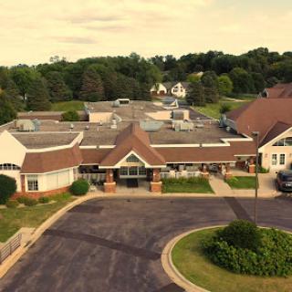 Aerial view of a well-maintained residential building surrounded by lush greenery.