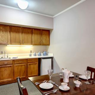 A cozy kitchen and dining area with a neatly set table.