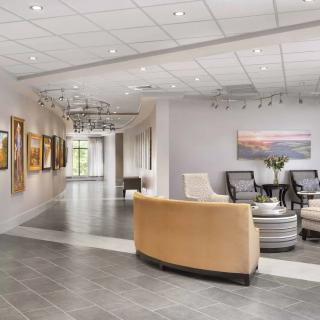A modern lobby with comfortable seating and artwork on the walls.
