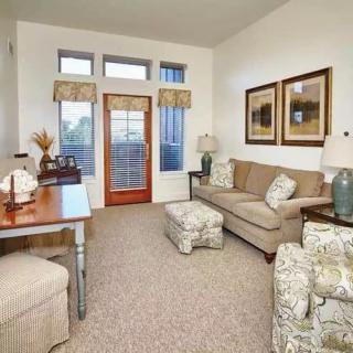 A cozy living room with a sofa, armchair, and decorative elements.