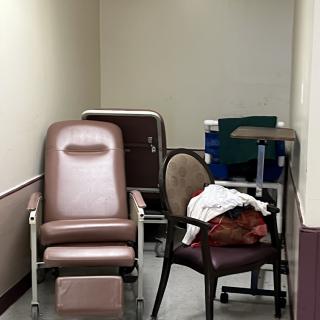 A small corner with several chairs and a recliner, possibly in a hospital waiting area.
