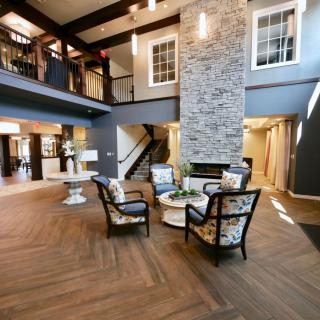 A modern lobby featuring a stone fireplace and a cozy seating area.