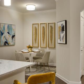 A modern dining area with elegant artwork and contemporary furnishings.