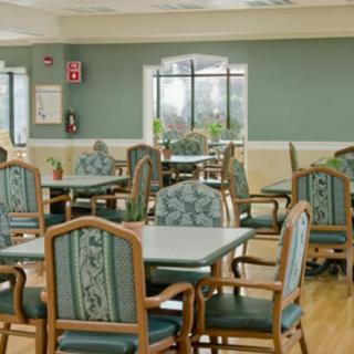 Empty dining area with neatly arranged tables and chairs.