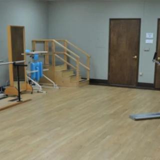 A physical therapy room equipped with various rehabilitation tools and exercise equipment.