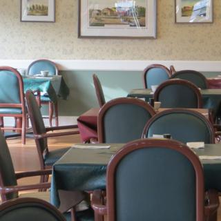 A cozy restaurant interior with neatly arranged tables and chairs.