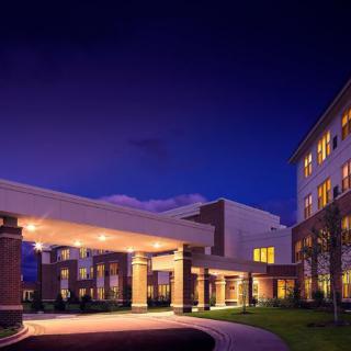 A well-lit building entrance at night showcasing modern architecture.