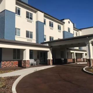A modern residential building with blue and white accents.