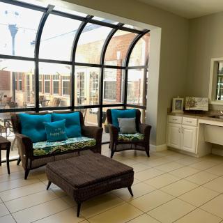 A cozy living room with large windows and comfortable seating.