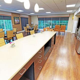 A modern and spacious kitchen with an island counter and dining area.