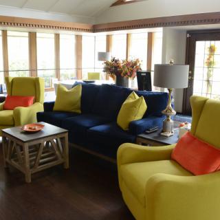 A modern living room with colorful furniture and bright decor.