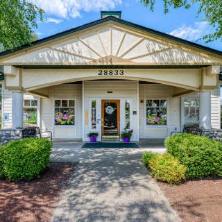 A welcoming front entrance to a residential house with well-maintained landscaping.