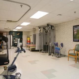 An indoor gym with various exercise equipment for fitness and rehabilitation.