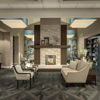 A modern living room featuring a cozy seating area around a stylish fireplace.