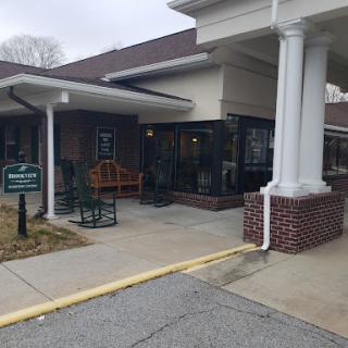 A view of the entrance to a restaurant with outdoor seating.