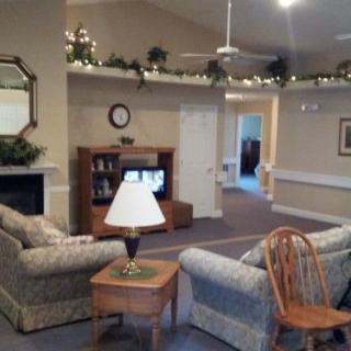 A cozy living room with sofas, a TV, and home decor.