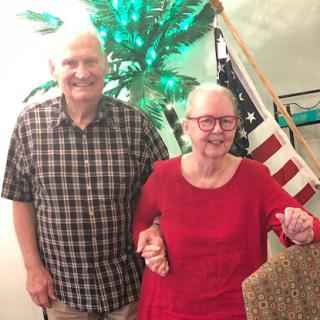 A cheerful couple enjoying their time together, surrounded by festive decorations.