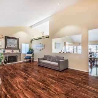 Spacious living room with hardwood floors and a cozy fireplace.