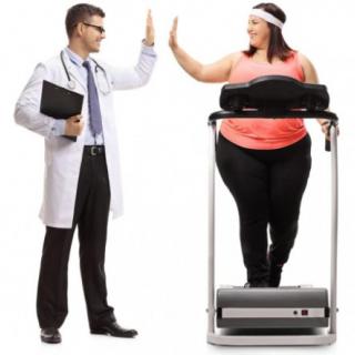 A doctor and patient exchanging a high five, symbolizing support and encouragement during a fitness session on a treadmill.