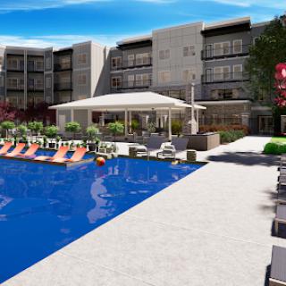 A modern hotel featuring a spacious outdoor pool and relaxing lounge area.