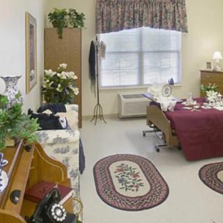 A cozy and well-decorated bedroom interior with plants and furniture.