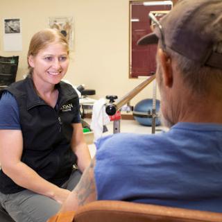 A healthcare professional engages in a conversation with a patient during a consultation.