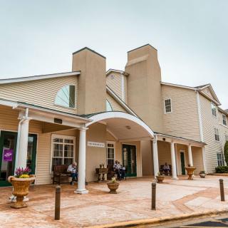The exterior of a hotel building featuring an entrance with an awning.
