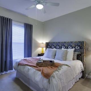 A cozy bedroom with a comfortable bed, decorative pillows, and a stylish headboard.