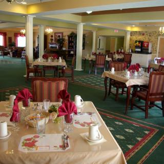 Elegant dining room with neatly arranged tables and chairs.
