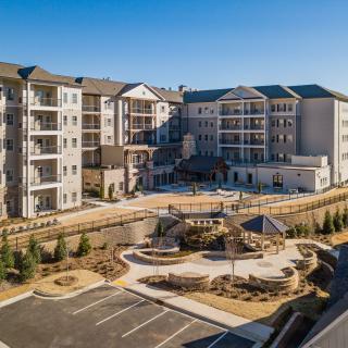 A modern residential apartment complex with landscaped outdoor areas.