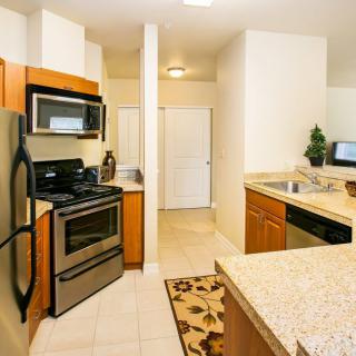 A modern kitchen with stainless steel appliances and granite countertops.