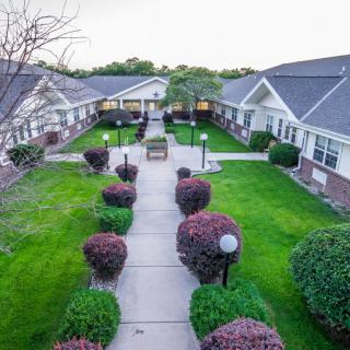 A tranquil courtyard surrounded by well-maintained gardens and residential buildings.